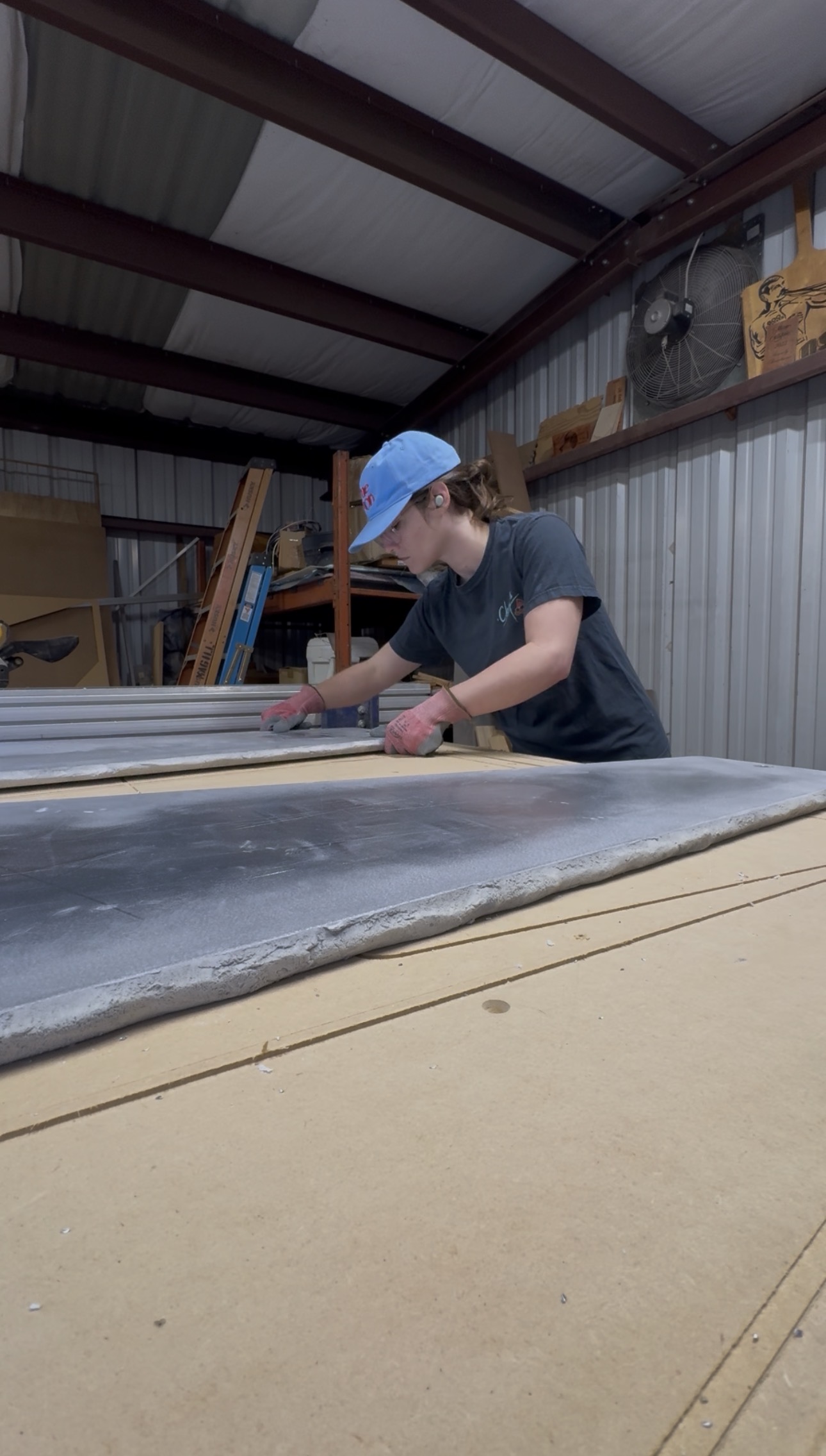 a woman positioning a panel onto a cnc machine