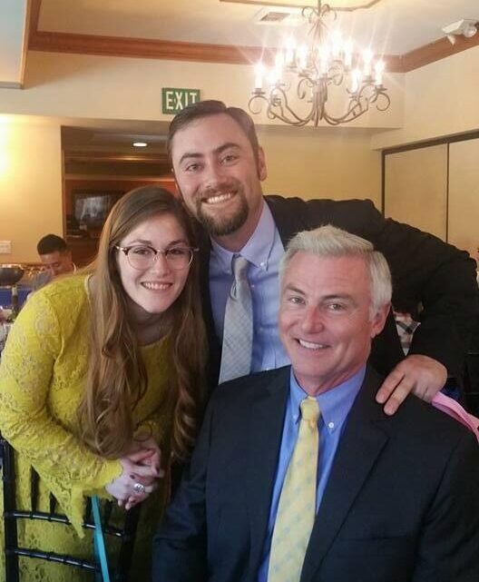 photo of 3 people in a banquet hall, smiling
